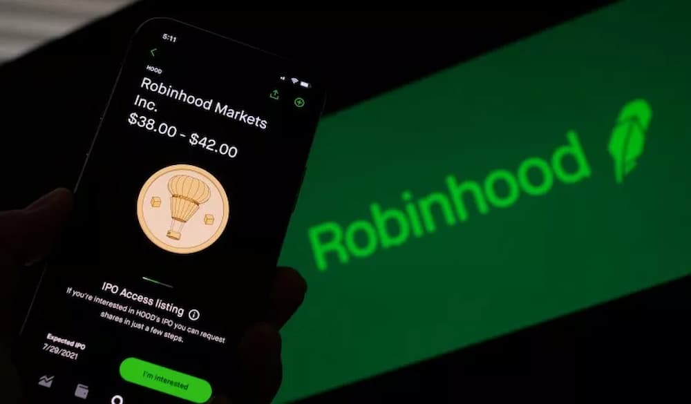 More than five million customers were affected by a hack on Robinhood Markets on Monday causing Redditors on the WallStreetBets forum to once again take aim at the stock trading app. Pictured: This photo illustration shows a person looking at a smartphone with the projected Robinhood (HOOD) price shares in Los Angeles, July 27, 2021. CHRIS DELMAS/AFP VIA GETTY IMAGES