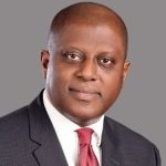 Portrait of Yemi Cardoso, the newly appointed Governor of the Central Bank of Nigeria, posing in a formal suit against a professional backdrop