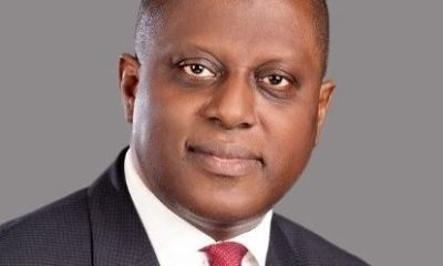 Portrait of Yemi Cardoso, the newly appointed Governor of the Central Bank of Nigeria, posing in a formal suit against a professional backdrop