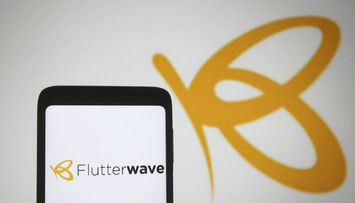 Flutterwave logo and Flutterwave's Swap app displayed on smartphone screen, representing the new digital forex trading solution.